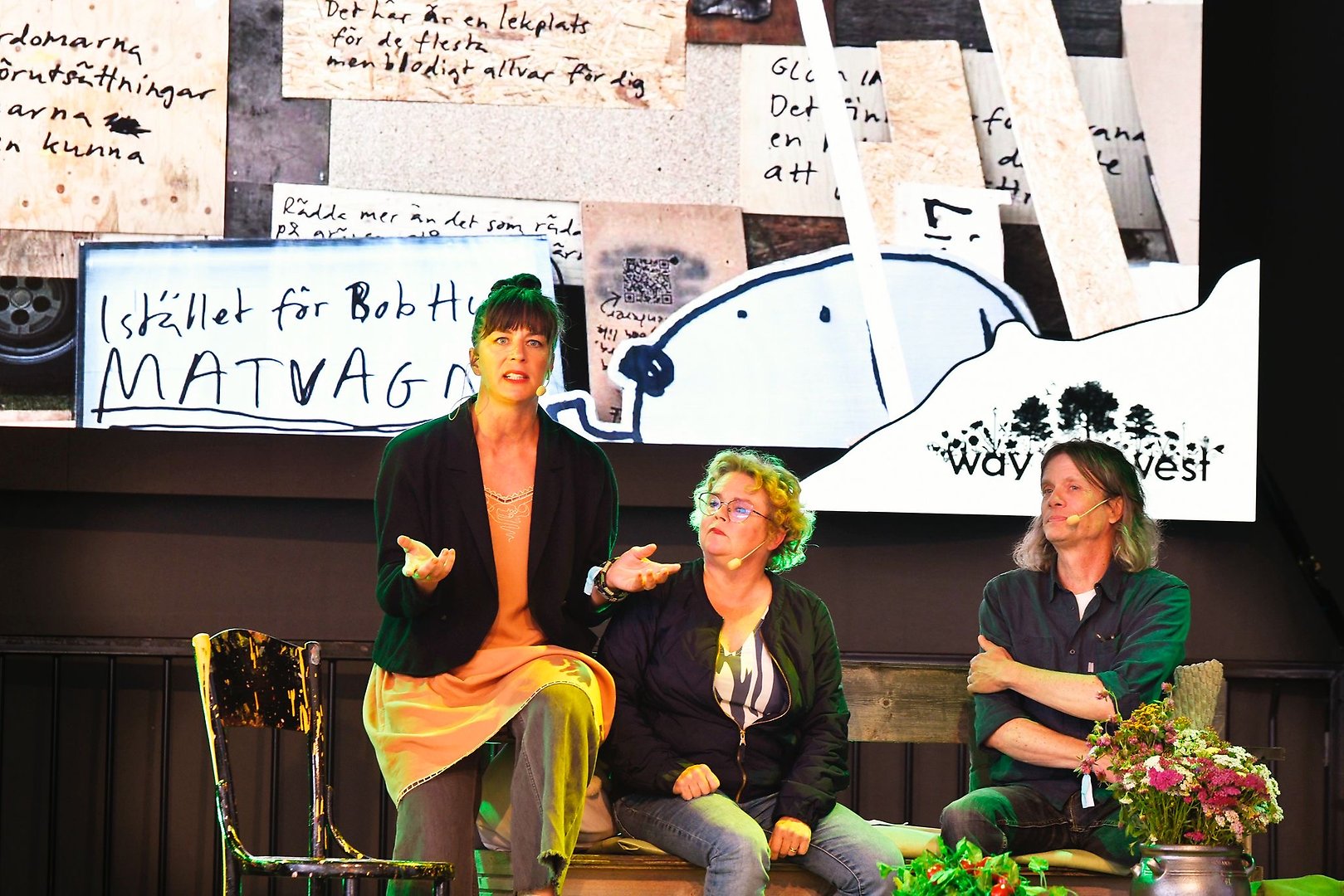 Three people on stage at Greentopia