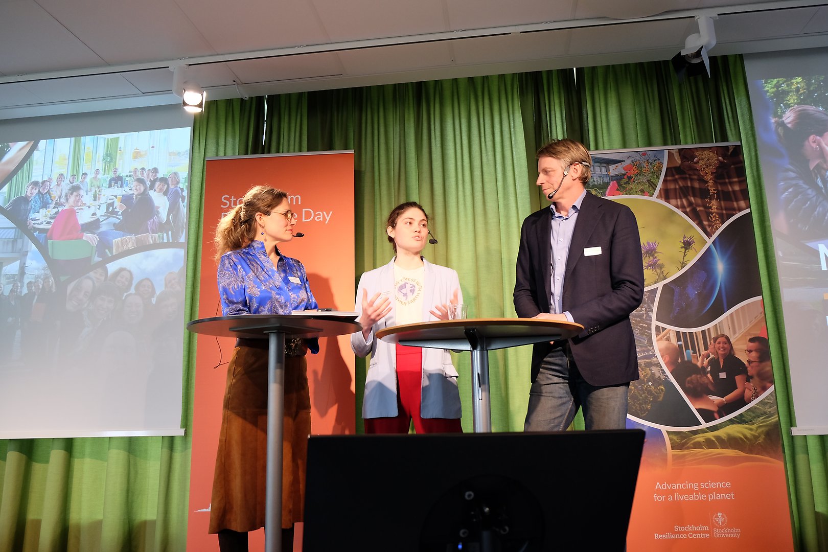 Three people on a stage discussing